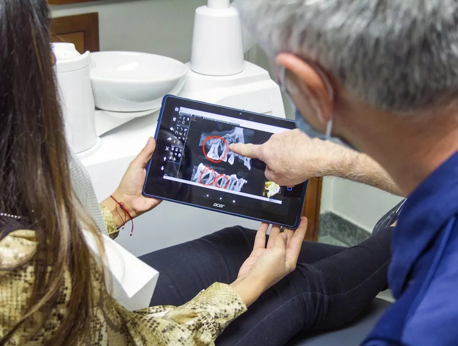 Dentist reviewing a digital dental X-ray with a patient on a tablet
